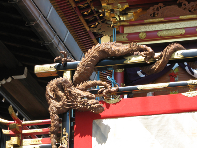 A carved dragon on a float